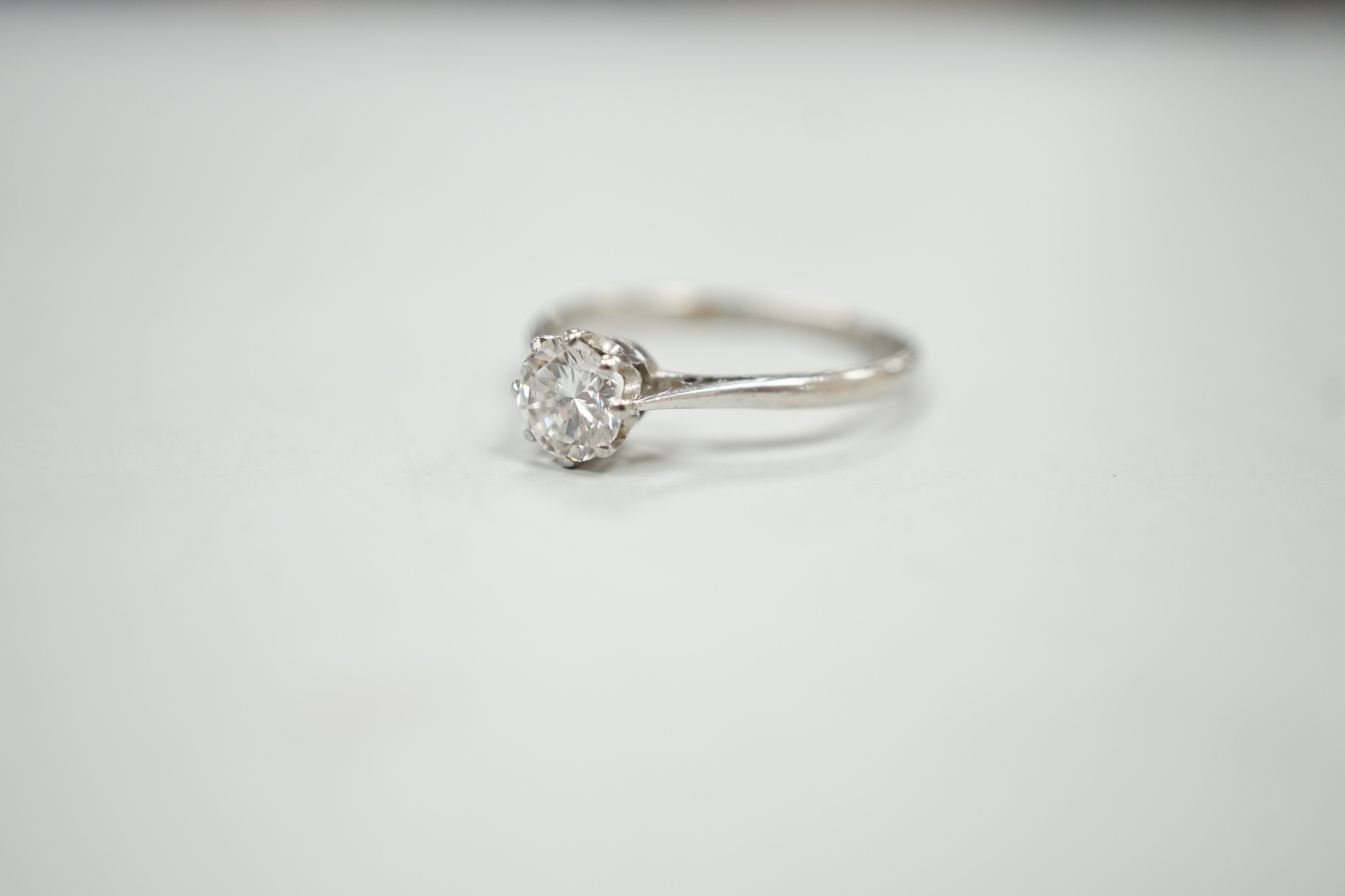 A white metal (stamped plat) and solitaire diamond ring, size P, gross weight 2.9 grams